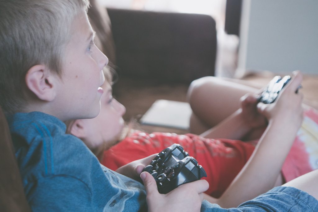 Crianças segurando controle de videogame